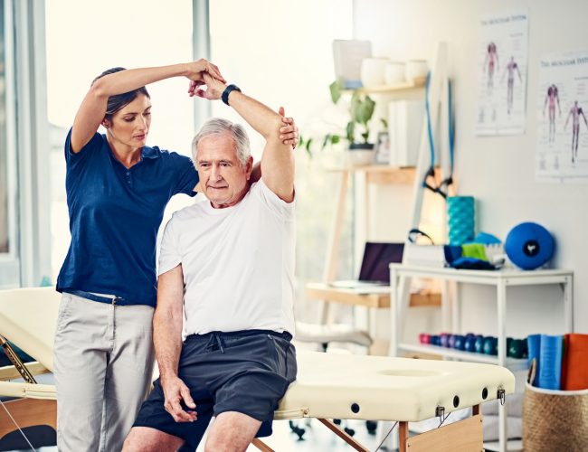 Cropped shot of an attractive young female physiotherapist working with a senior male patient